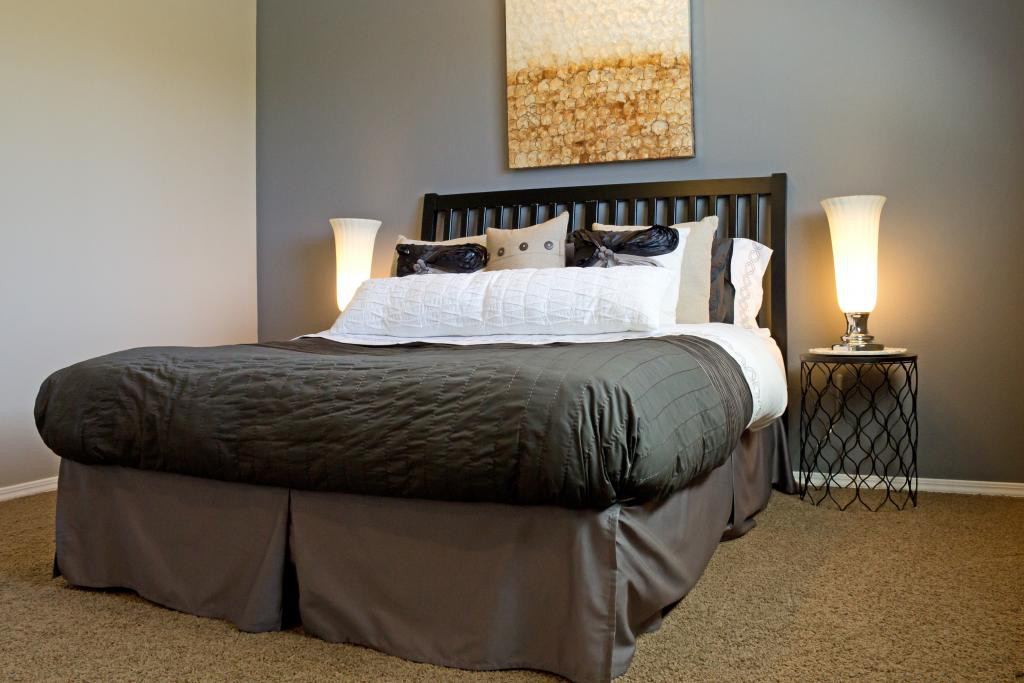 bed in bedroom with grey sheets